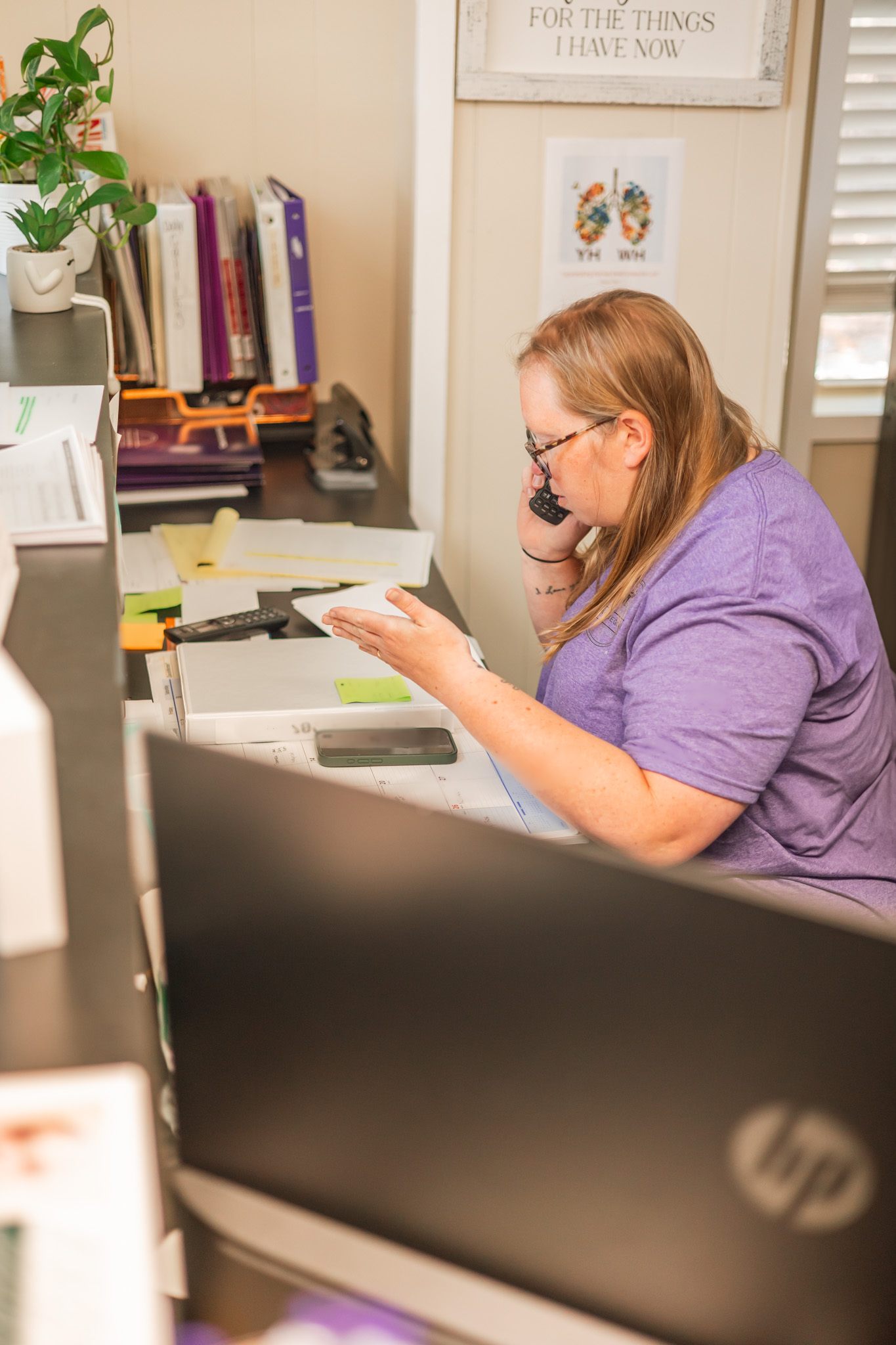 Team member on the phone at her desk